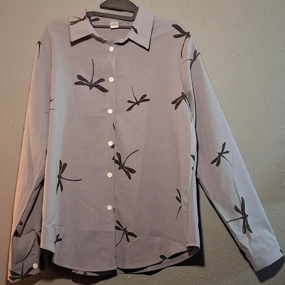 Light gray button-up blouse features black dragonfly